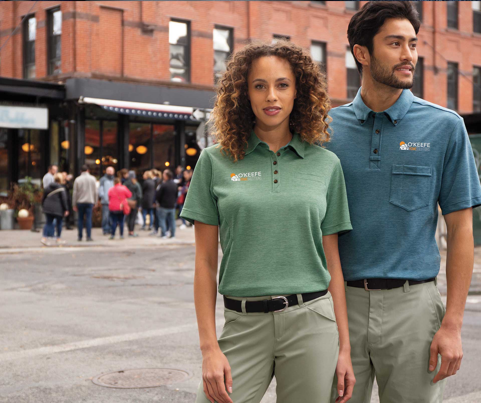 Image of man and woman wearing aramark polo shirts with embroidered logos